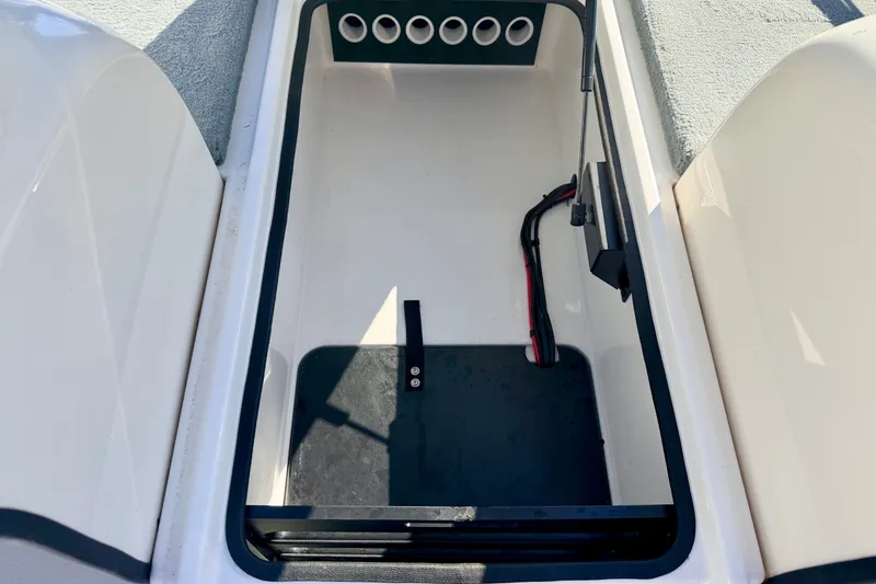 Slide: The Image of Open storage compartment in 2007 Stratos 375 XF boat, featuring organized interior space. - 58