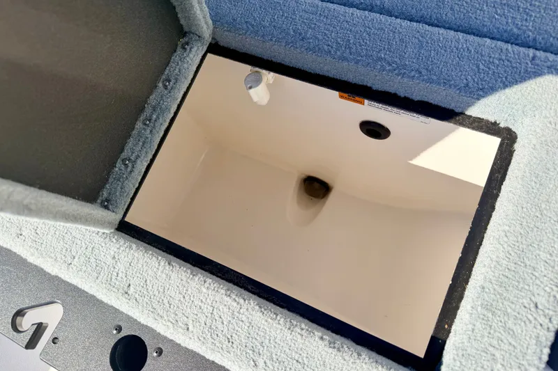 Slide: The Image of Open storage compartment in 2007 Stratos 375 XF boat, featuring carpeted interior. - 31