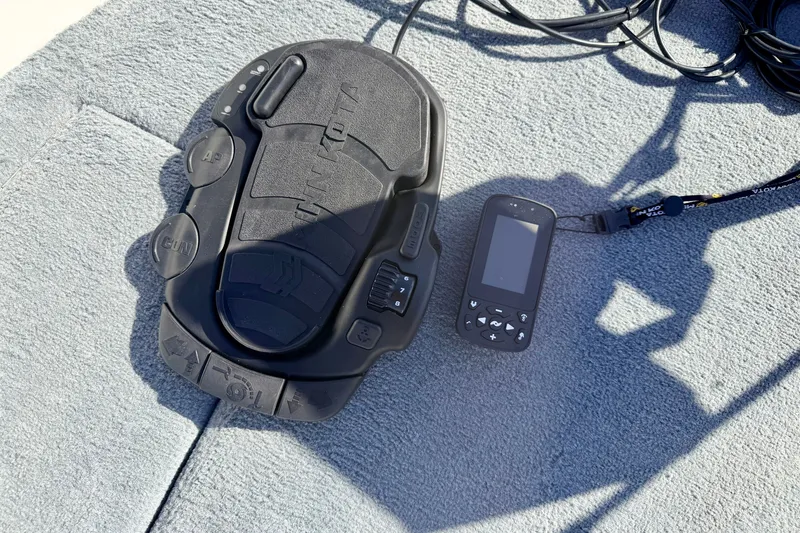 Slide: The Image of Foot pedal and remote control on Stratos 375 XF, 2007 model, on a textured surface. - 67