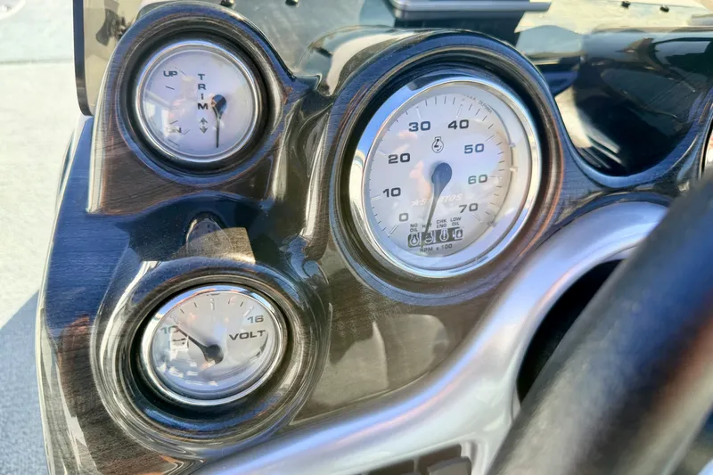 Slide: The Image of Dashboard of a 2007 Stratos 375 XF boat with gauges for trim, speed, and voltage. - 40