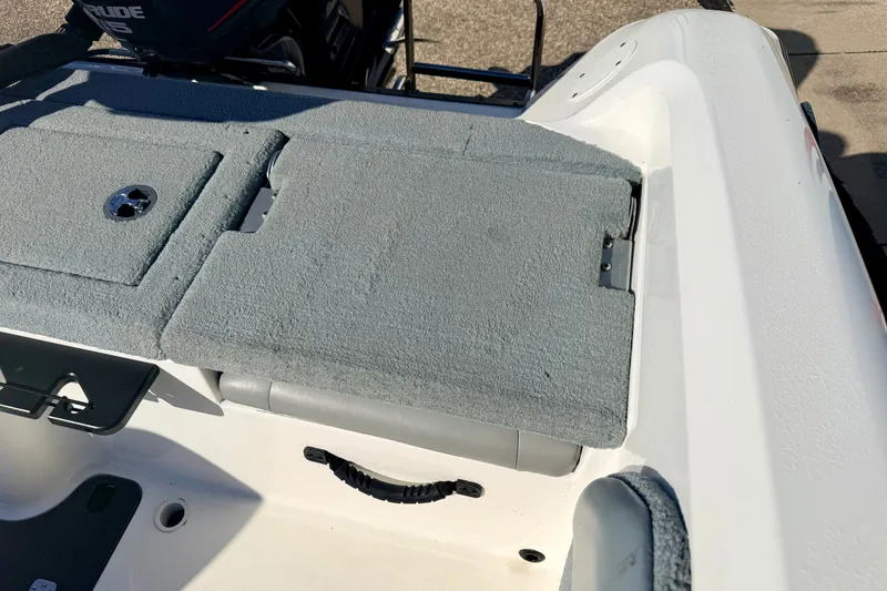 Slide: The Image of 2007 Stratos 375 XF boat interior with gray carpeted deck and storage compartments. - 27