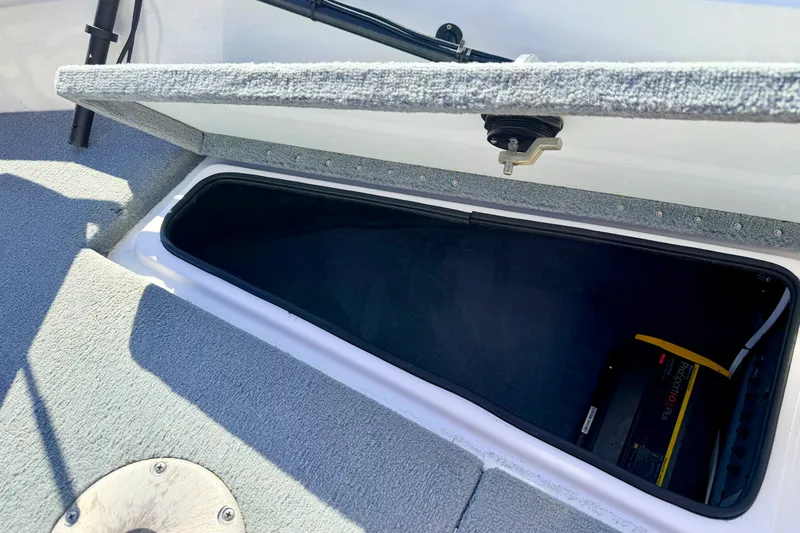 Slide: The Image of Open storage compartment in 2007 Stratos 375 XF boat, featuring carpeted interior and visible equipment. - 63