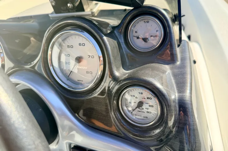 Slide: The Image of Dashboard of a 2007 Stratos 375 XF boat showing speedometer, fuel, and pressure gauges. - 41