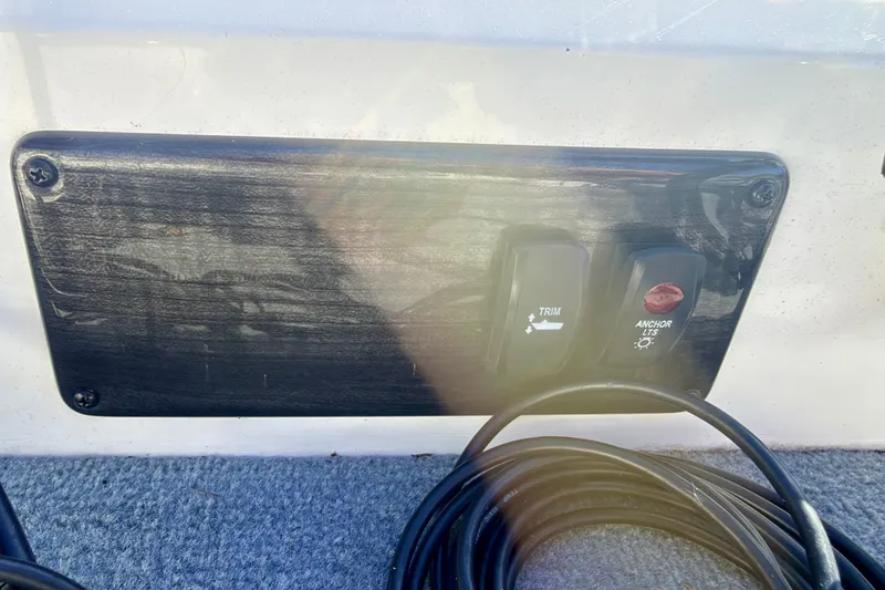 Slide: The Image of Control panel with trim and anchor light switches on a 2007 Stratos 375 XF boat. - 69
