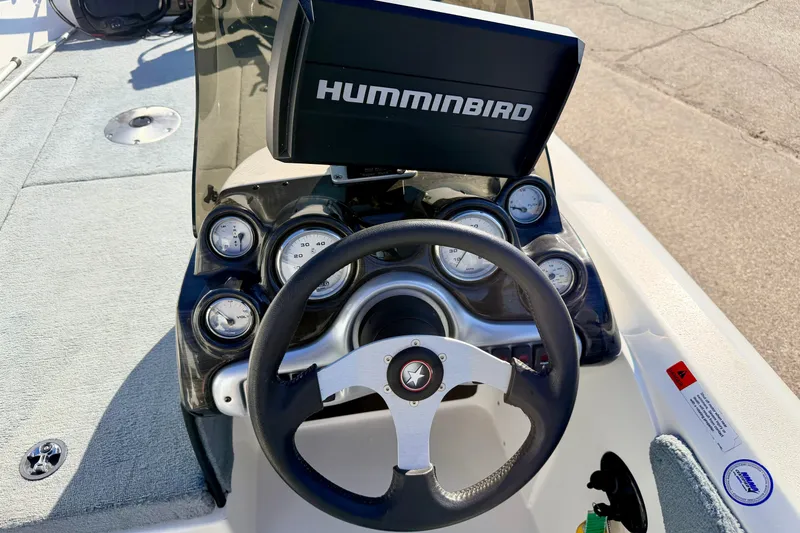 Slide: The Image of Steering console of 2007 Stratos 375 XF boat with Humminbird display and gauges. - 39