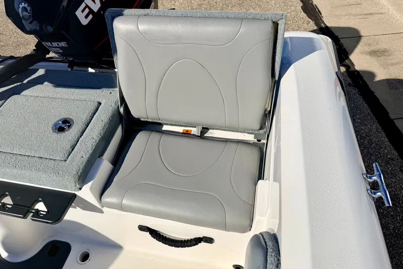 Slide: The Image of 2007 Stratos 375 XF boat seat with gray upholstery and Evinrude motor in background. - 28