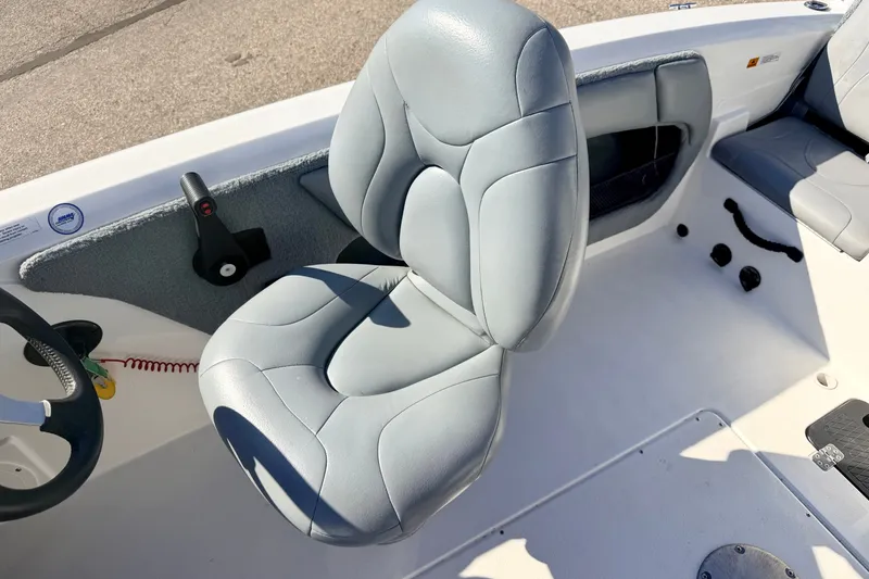 Slide: The Image of Captain's seat in a 2007 Stratos 375 XF boat, featuring gray upholstery and control panel. - 37