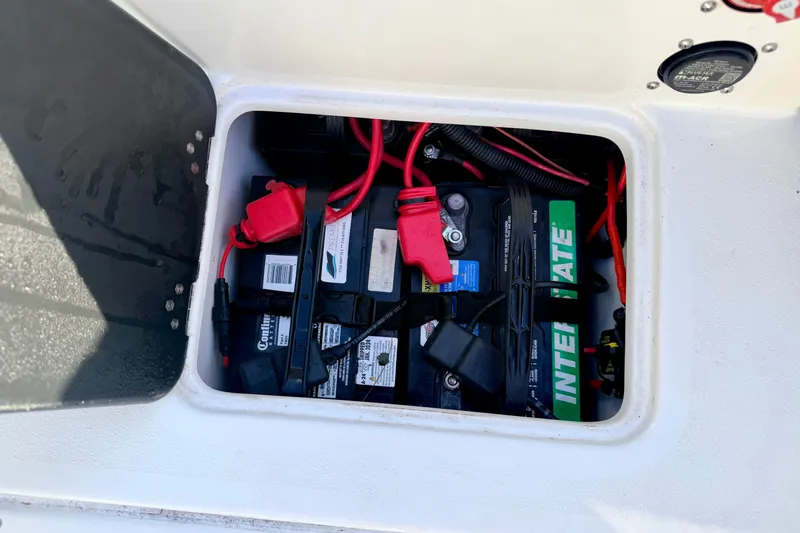 Slide: The Image of Battery compartment of a 2007 Stratos 375 XF boat with visible wiring and connections. - 55