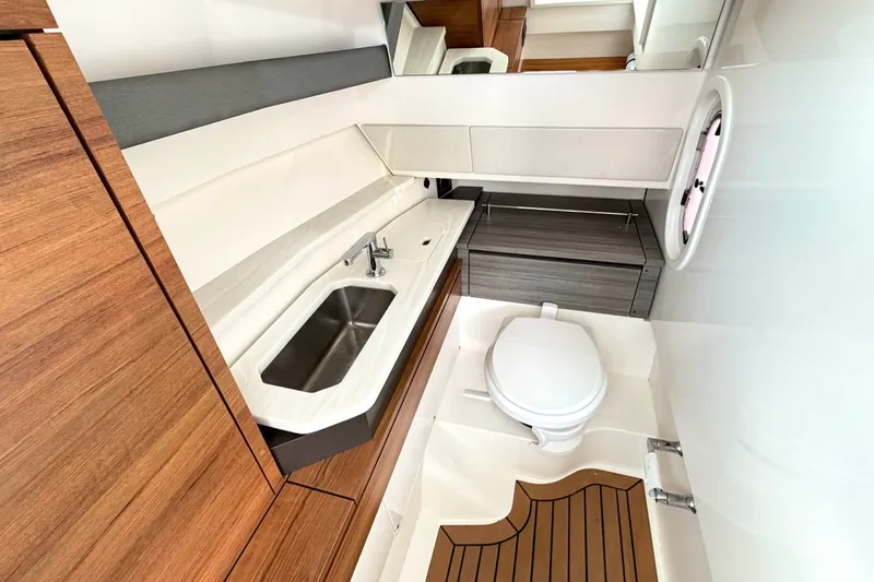 Slide: The Image of Luxurious 2020 Tiara Sport 34 LX yacht bathroom with modern fixtures and wood accents. - 32