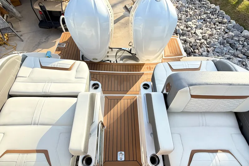 Slide: The Image of 2020 Tiara Sport 34 LX boat interior with white seating and dual engines. - 15