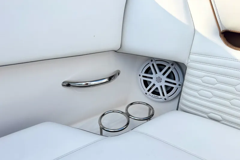 Slide: The Image of 2020 Tiara Sport 34 LX interior with speaker, cup holders, and chrome handle. - 45