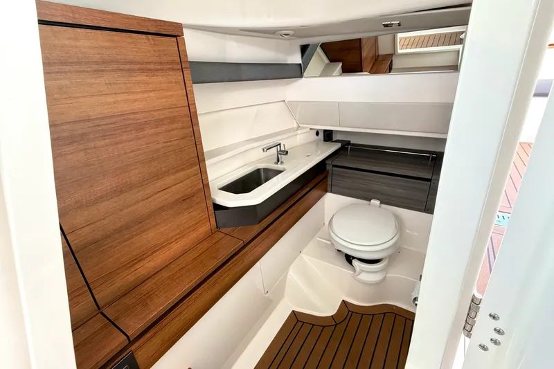 Slide: The Image of 2020 Tiara Sport 34 LX yacht bathroom with wood accents and modern fixtures. - 31