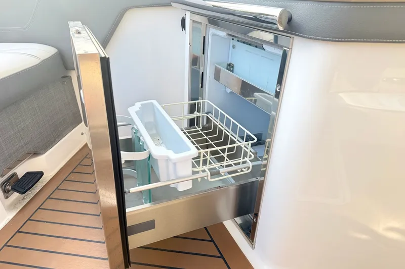 Slide: The Image of 2020 Tiara Sport 34 LX boat with open stainless steel drawer refrigerator. - 19