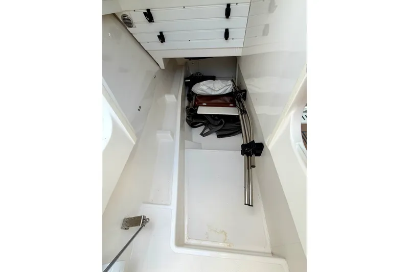 Slide: The Image of Storage compartment in a 2020 Tiara Sport 34 LX boat, featuring organized equipment. - 43