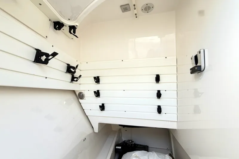 Slide: The Image of Interior storage compartment of 2020 Tiara Sport 34 LX boat with mounted holders. - 42