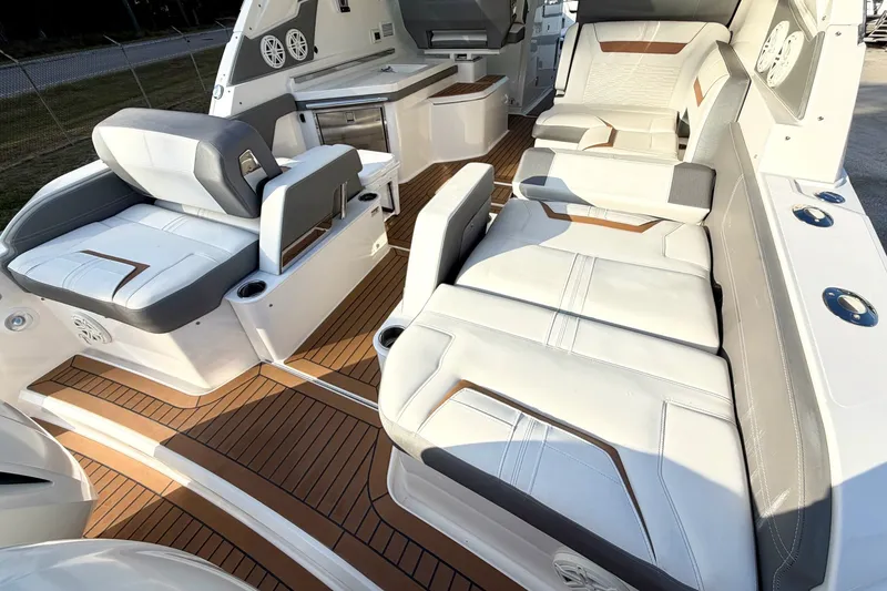 Slide: The Image of 2020 Tiara Sport 34 LX boat interior with luxurious seating and teak flooring. - 11