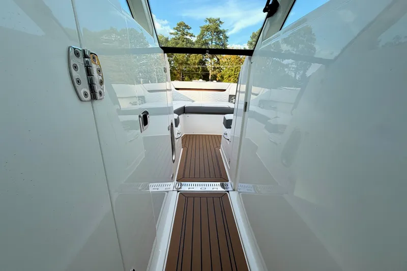 Slide: The Image of 2020 Tiara Sport 34 LX boat interior with sleek design and wooden flooring. - 36