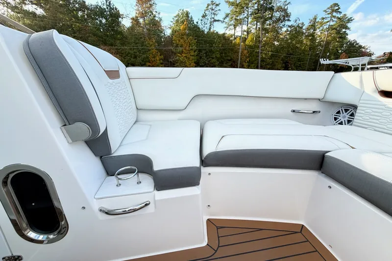 Slide: The Image of 2020 Tiara Sport 34 LX boat interior with white and gray seating, wooden flooring. - 39