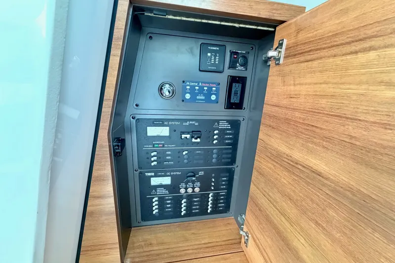 Slide: The Image of Electrical panel inside 2020 Tiara Sport 34 LX boat, featuring AC and DC systems. - 35