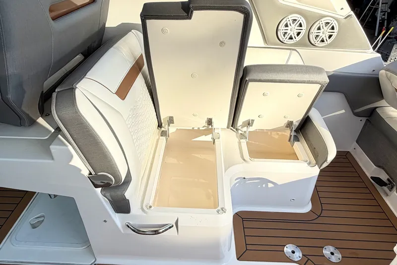 Slide: The Image of 2020 Tiara Sport 34 LX boat seating with storage compartments open, showcasing luxury design. - 20