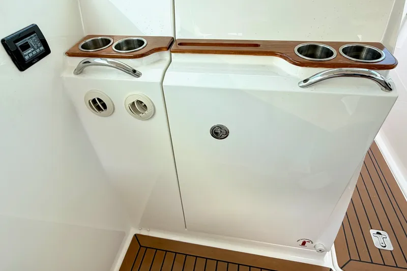 Slide: The Image of 2020 Tiara Sport 34 LX boat interior with cup holders and control panel. - 30