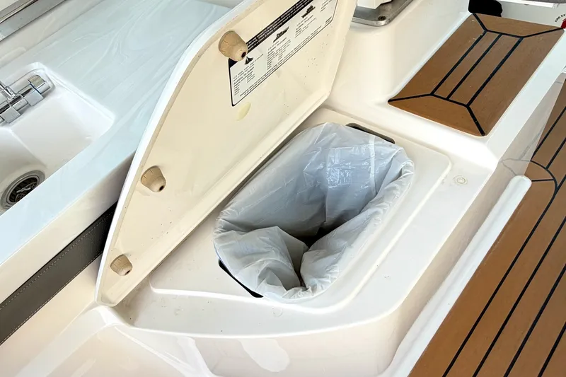Slide: The Image of 2020 Tiara Sport 34 LX boat with built-in trash compartment and teak flooring. - 21