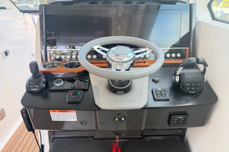 Slide: The Image of Helm of 2020 Tiara Sport 34 LX boat with steering wheel and control panels. - 27