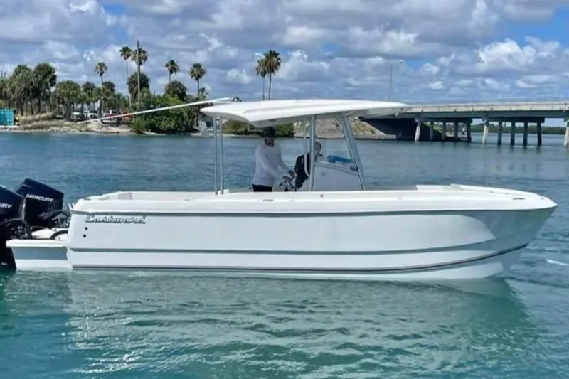 The Image of 2024 Eastward Seaward 24' boat on calm water with scenic background. - 1