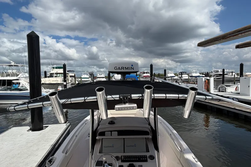 Slide: The Image of 2002 Grady-White Release 283 boat docked, featuring Garmin equipment under cloudy skies. - 18