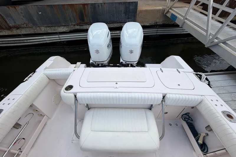 Slide: The Image of 2002 Grady-White Release 283 boat with twin Suzuki outboard engines at dock. - 7