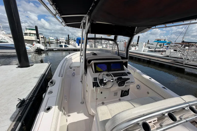 Slide: The Image of 2002 Grady-White Release 283 boat docked at marina, featuring helm and navigation equipment. - 11