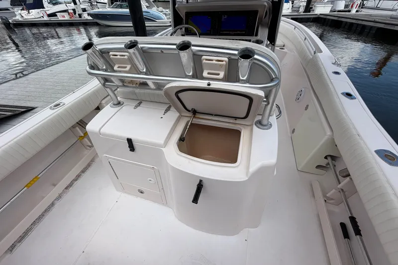 Slide: The Image of 2002 Grady-White Release 283 boat interior with open storage compartment at marina. - 6