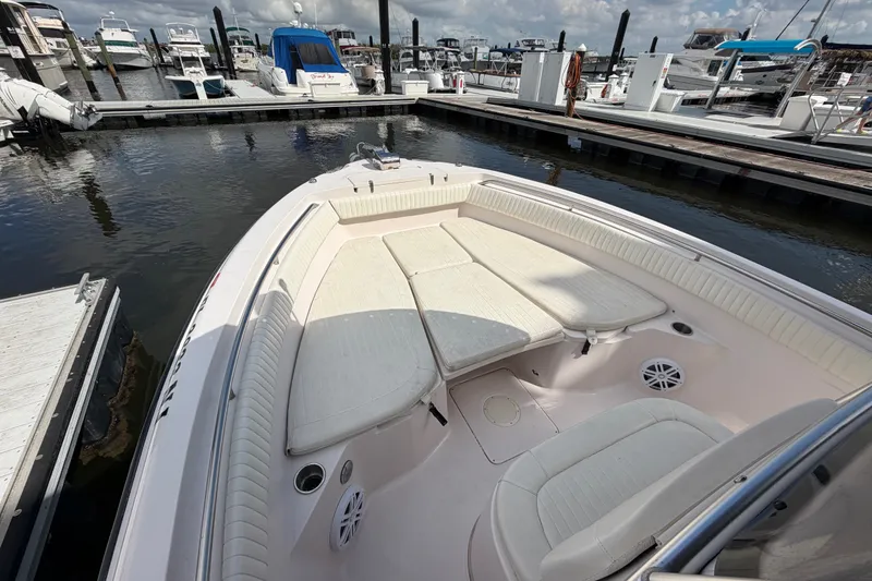 Slide: The Image of 2002 Grady-White Release 283 boat docked, featuring spacious seating and a clean deck. - 15
