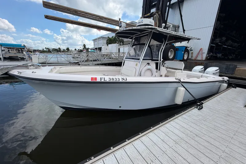 Slide: The Image of 2002 Grady-White Release 283 boat docked at marina with clear skies. - 2