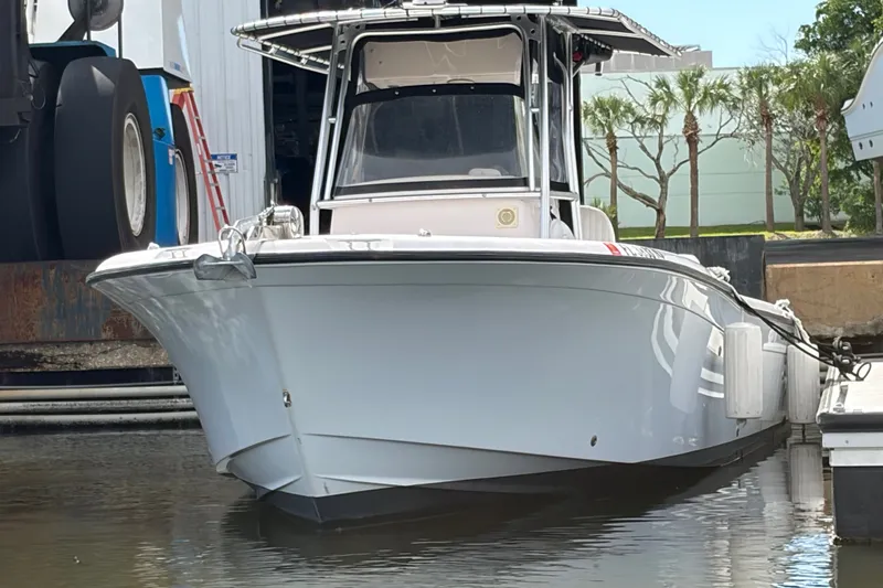 Slide: The Image of 2002 Grady-White Release 283 boat docked, front view, with a sleek white hull. - 1