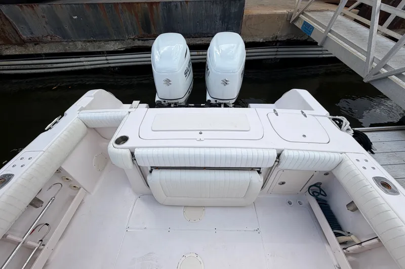 Slide: The Image of 2002 Grady-White Release 283 boat with twin Suzuki outboard motors at dock. - 8