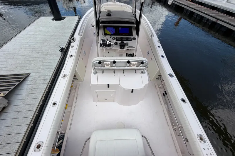 Slide: The Image of 2002 Grady-White Release 283 boat interior with helm, docked at marina. - 4