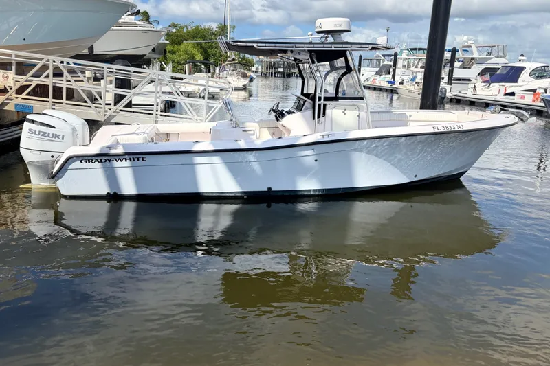 Slide: The Image of 2002 Grady-White Release 283 boat docked, featuring Suzuki outboard motor. - 20