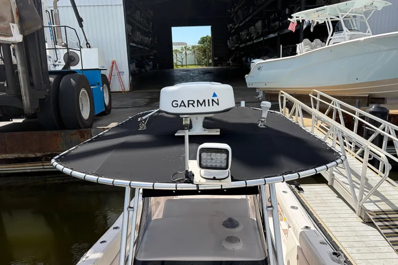 Slide: The Image of 2002 Grady-White Release 283 boat with Garmin radar, docked near a marina. - 19