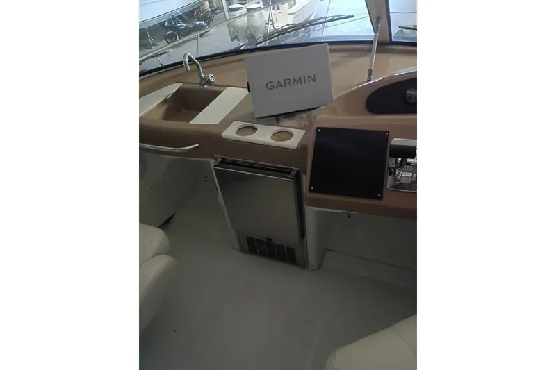 Slide: The Image of 2003 Carver 350 Mariner helm with Garmin navigation, sink, and control panel. - 3
