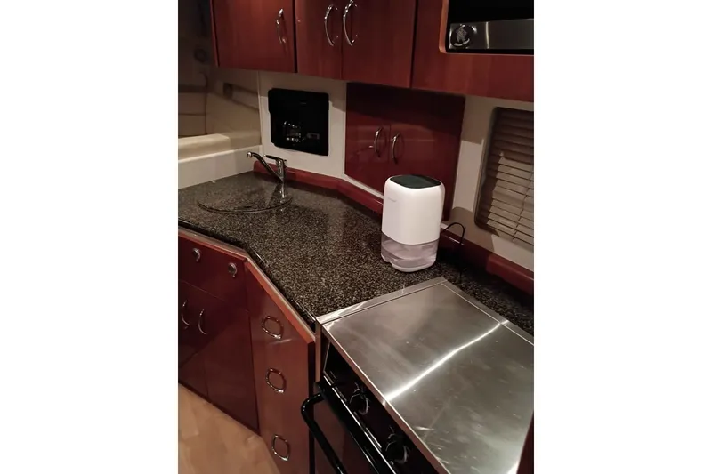 Slide: The Image of 2003 Carver 350 Mariner kitchen with granite countertop, sink, and modern appliances. - 7