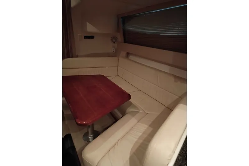 Slide: The Image of Interior of 2003 Carver 350 Mariner with beige seating and wooden table. - 9
