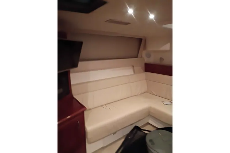 Slide: The Image of Interior of 2003 Carver 350 Mariner yacht with beige seating and ambient lighting. - 8