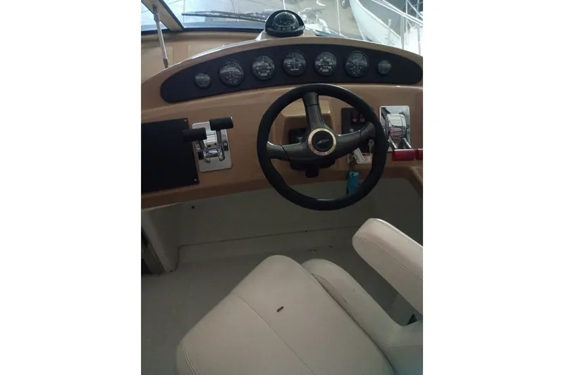 Slide: The Image of 2003 Carver 350 Mariner helm with steering wheel and instrument panel. - 2