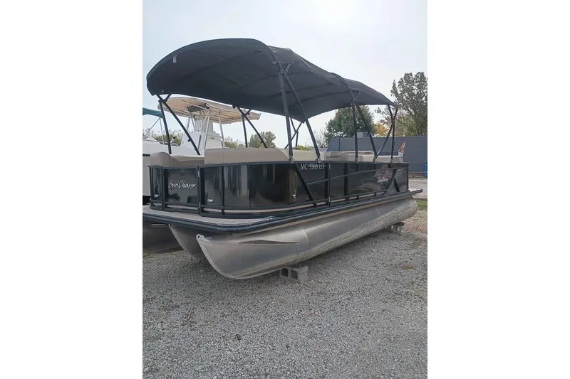 The Image of 2023 SunChaser Geneva Cruise 22 CRS pontoon boat with canopy, parked on gravel. - 0