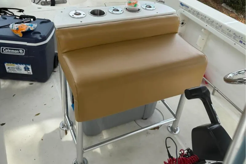 Slide: The Image of Brown cushioned seat on 2008 Triton 225 CC boat with control panel and cooler. - 8