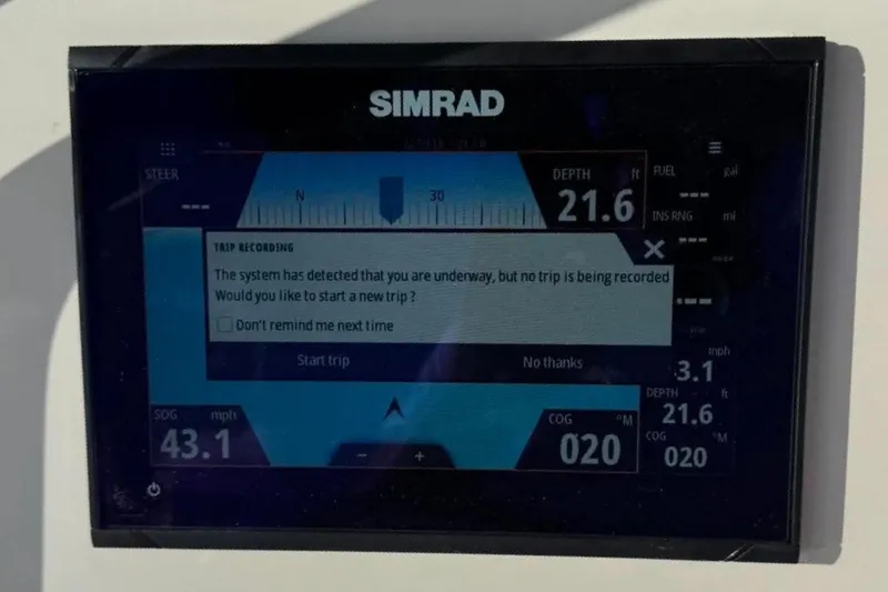 Slide: The Image of Simrad marine display showing trip recording prompt on a 2008 Triton 225 CC boat. - 10