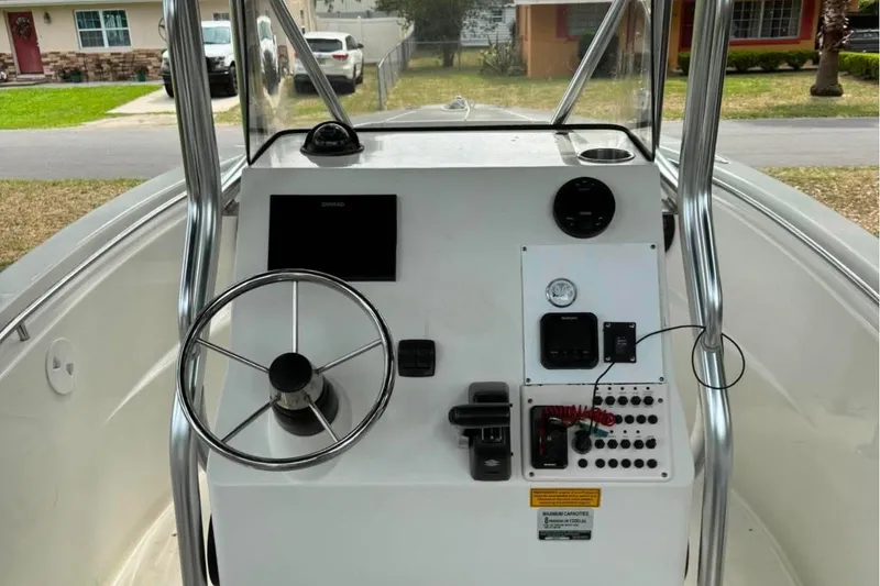 Slide: The Image of 2008 Triton 225 CC boat console with steering wheel and control panel. - 7