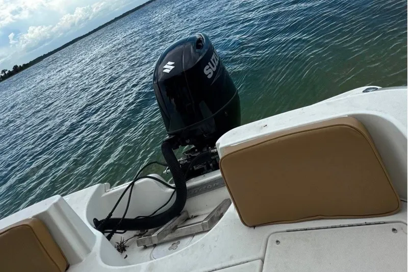 Slide: The Image of 2008 Triton 225 CC boat with Suzuki outboard motor on calm water. - 9