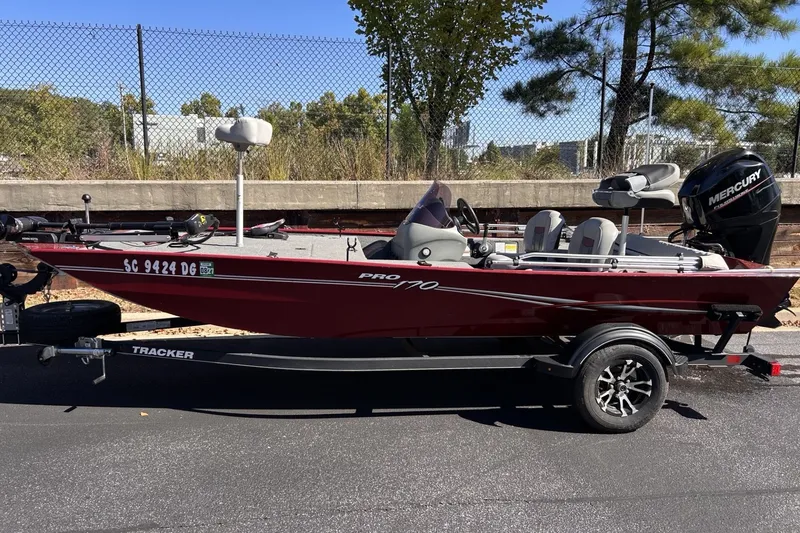 The Image of 2017 Tracker Pro 170 boat on trailer, parked outdoors with trees in background. - 0